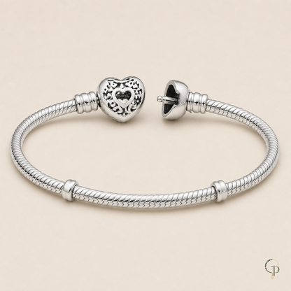 Open heart clasp construction and bare snake-chain bracelet detail