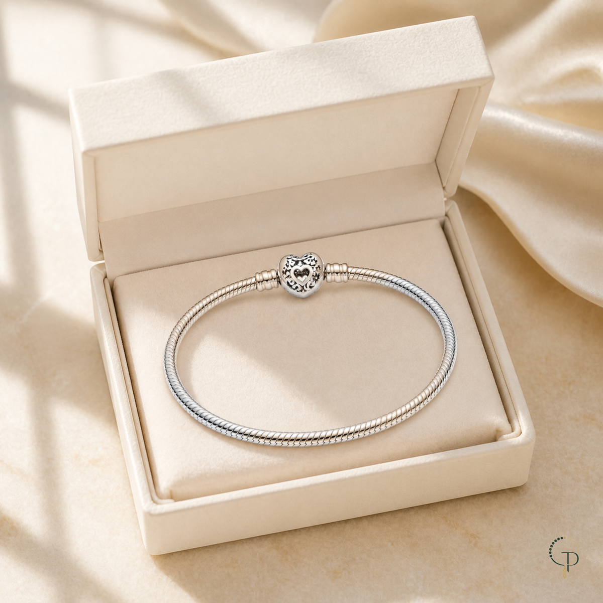Silver-color heart clasp bracelet displayed in an unbranded ivory box