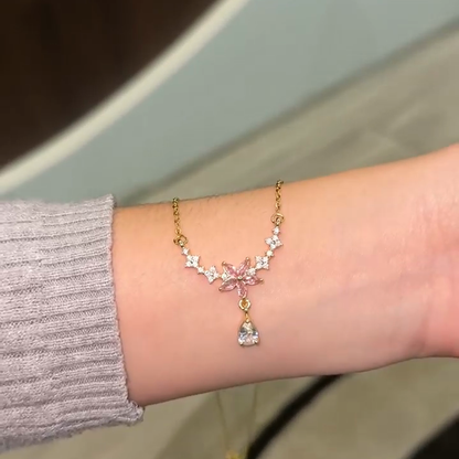 Pink blossom necklace shown on a forearm for visual scale