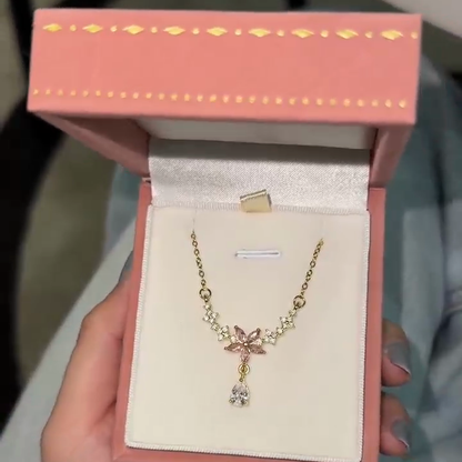 Pink blossom drop necklace displayed inside a pink jewelry box