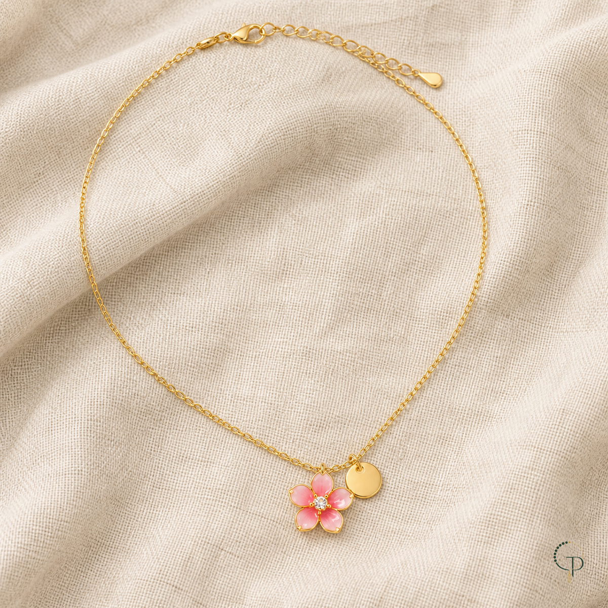 Full pink blossom pendant necklace arranged on oatmeal linen