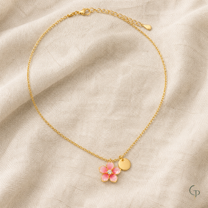 Full pink blossom pendant necklace arranged on oatmeal linen