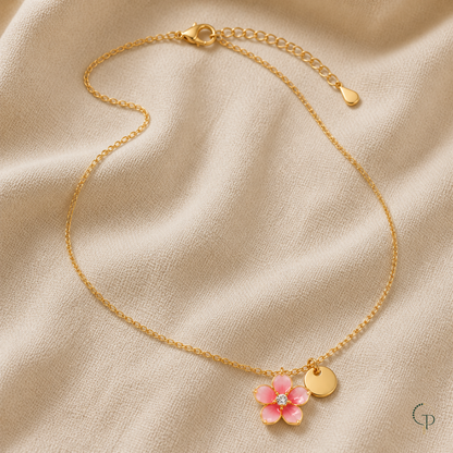 Detail of the necklace lobster clasp, extension links, flower pendant and round tag