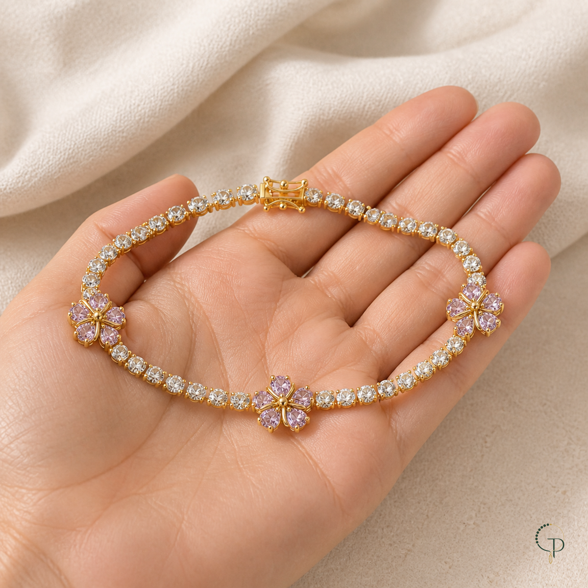 Three-blossom clear-stone bracelet displayed across an open palm