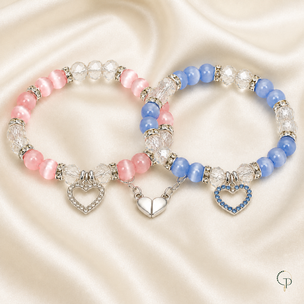 Pink and blue matching friendship bracelets arranged on cream silk