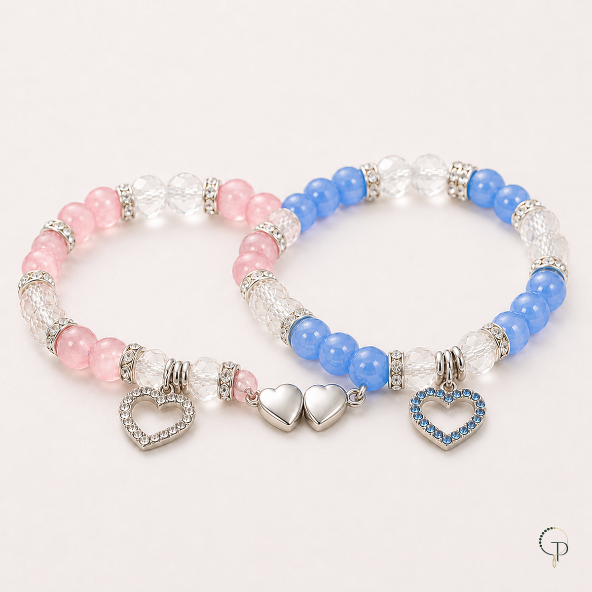 Pink and blue bracelets each with a complete silver heart magnetically joined