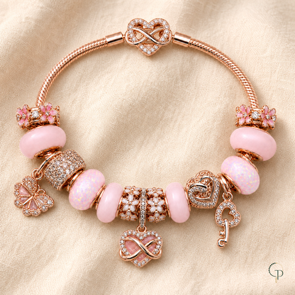 Complete pink rose-gold-color charm bracelet arranged on oatmeal linen
