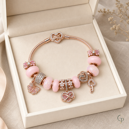 Pink infinity and blossom charm bracelet in an unbranded ivory jewelry box