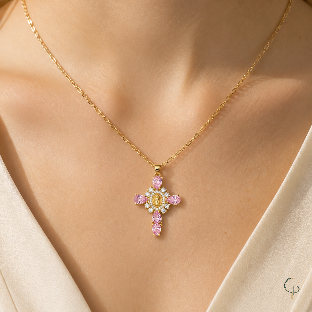 Gold-color pink teardrop pendant necklace worn at the collarbone