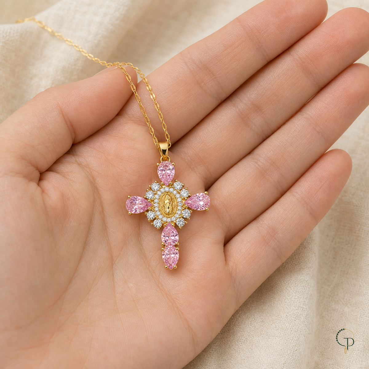 Five-stone pink pendant necklace displayed across an open palm