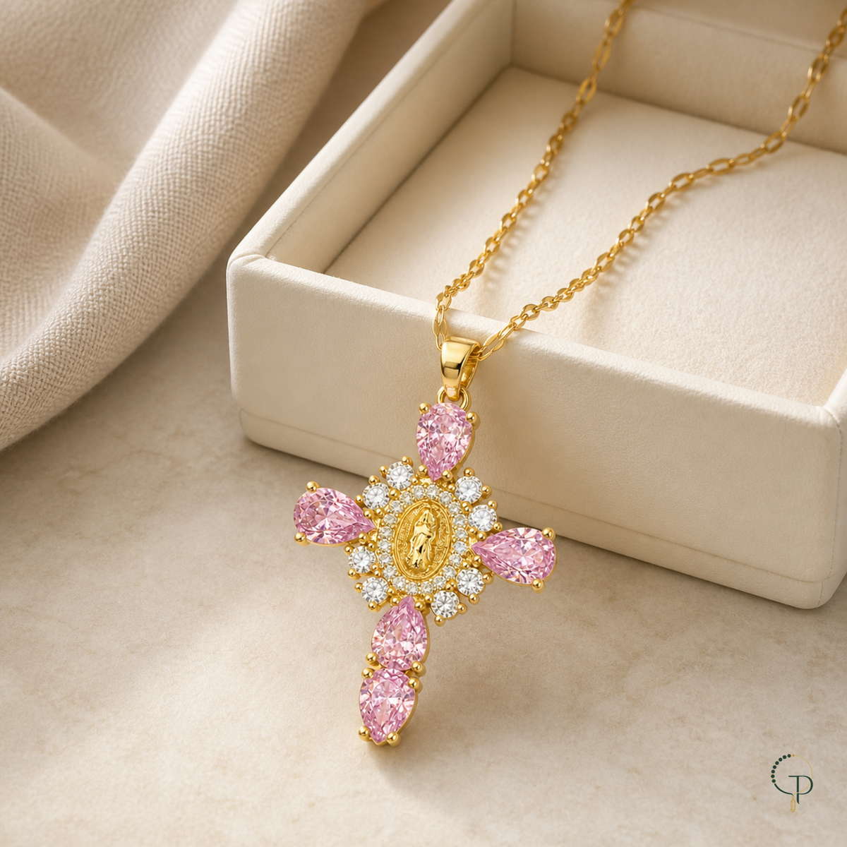 Pink teardrop halo pendant necklace beside an unbranded ivory jewelry box