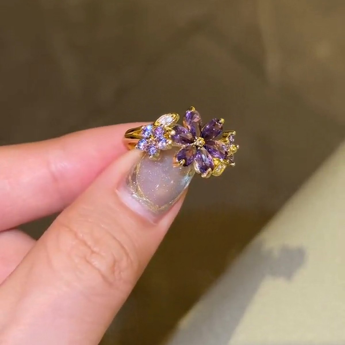 Close view of the large purple marquise-stone flower and smaller side clusters