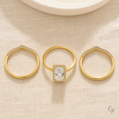 Three separate complete rings arranged on ivory linen