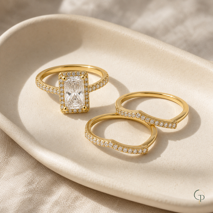 Solitaire ring and two separate curved bands on a ceramic dish