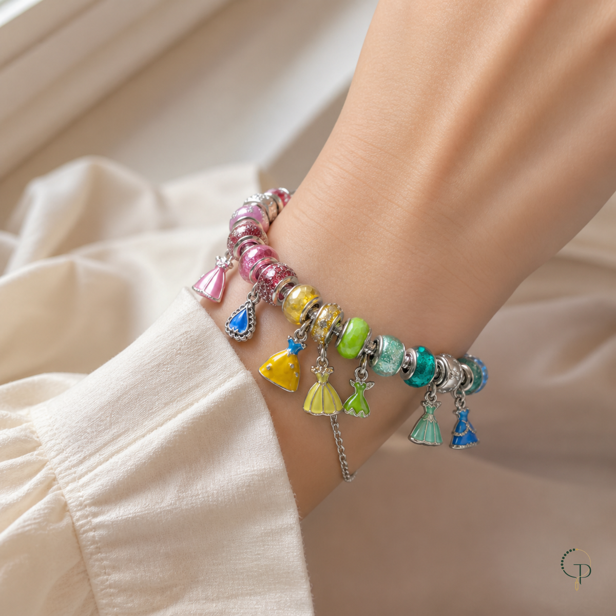 Complete rainbow fairytale dress charm bracelet worn around an anonymous wrist