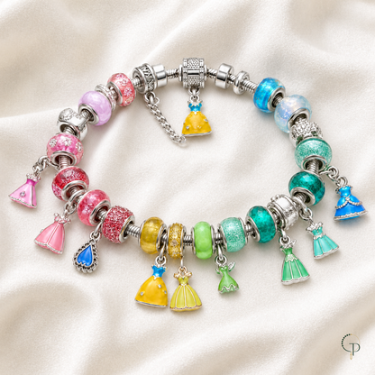 Complete rainbow charm bracelet arranged on ivory linen