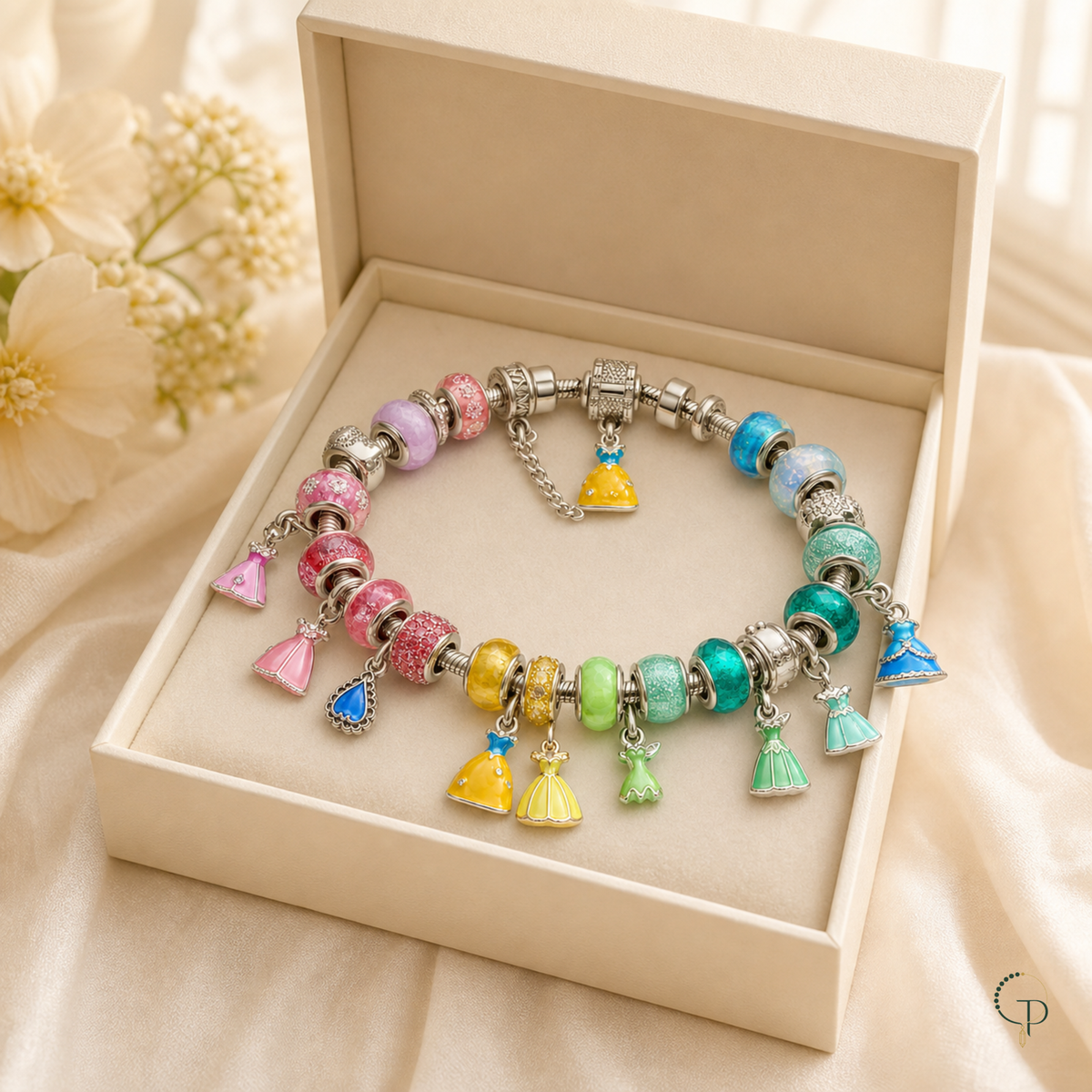 Rainbow dress charm bracelet displayed in an unbranded ivory box