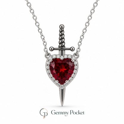 Red heart and silver-color sword pendant necklace on a white studio background