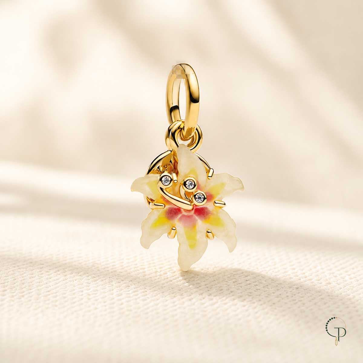 Gold-tone enamel flower pendant charm on warm ivory linen | PureNoi