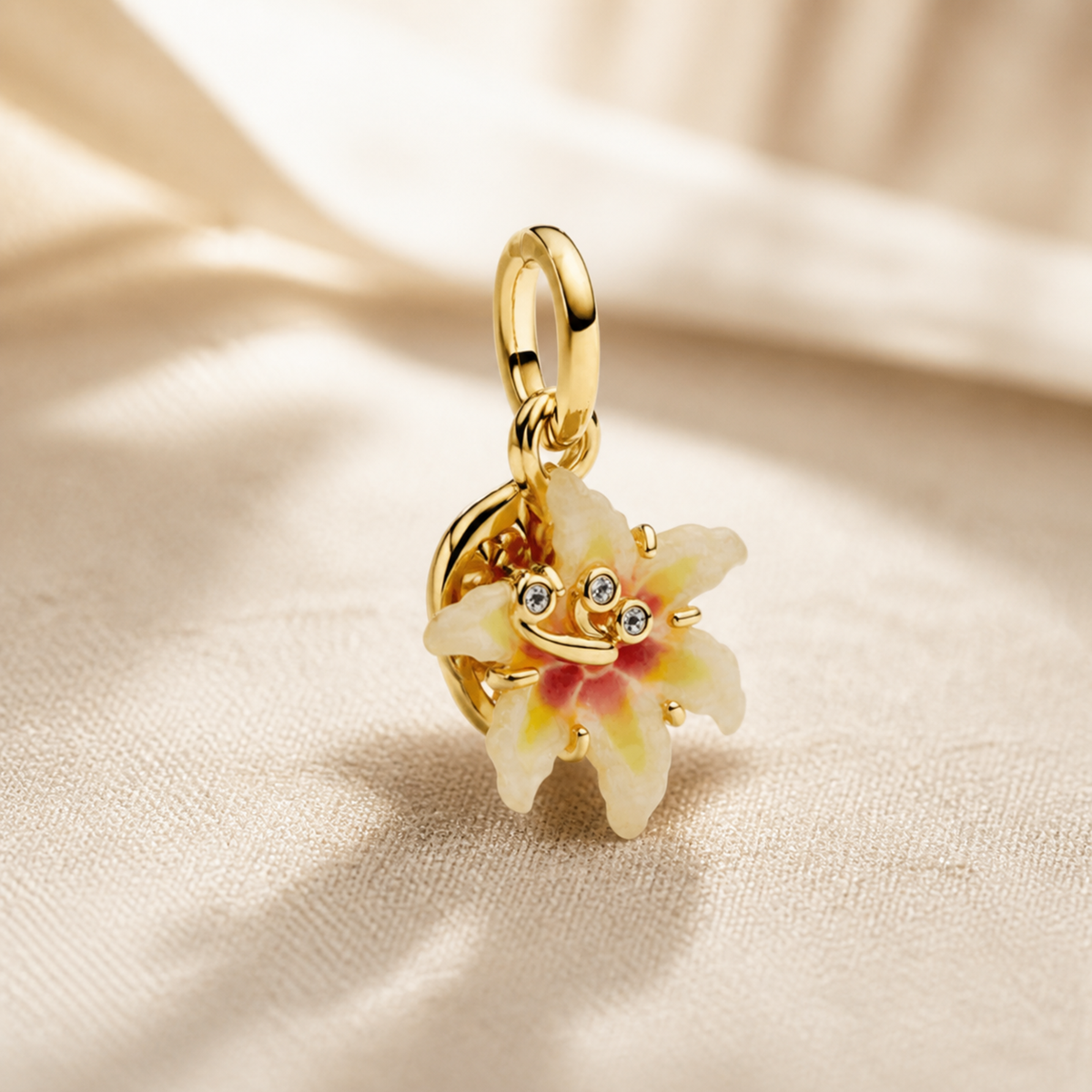 Side profile of gold-tone enamel flower charm showing layered petals