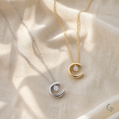 Gold and silver crescent moon crystal pendant necklaces on warm ivory linen | PureNoi