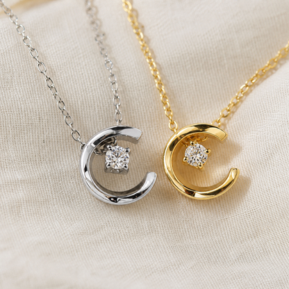 Close-up of gold and silver crescent moon crystal pendants