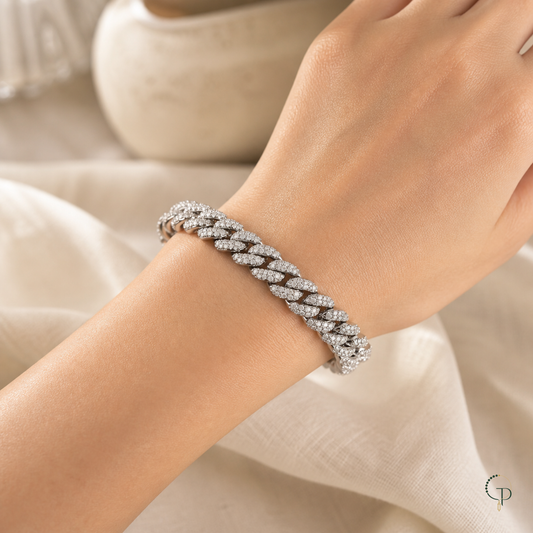 Wide silver-color pavé Cuban link bracelet worn around an anonymous wrist
