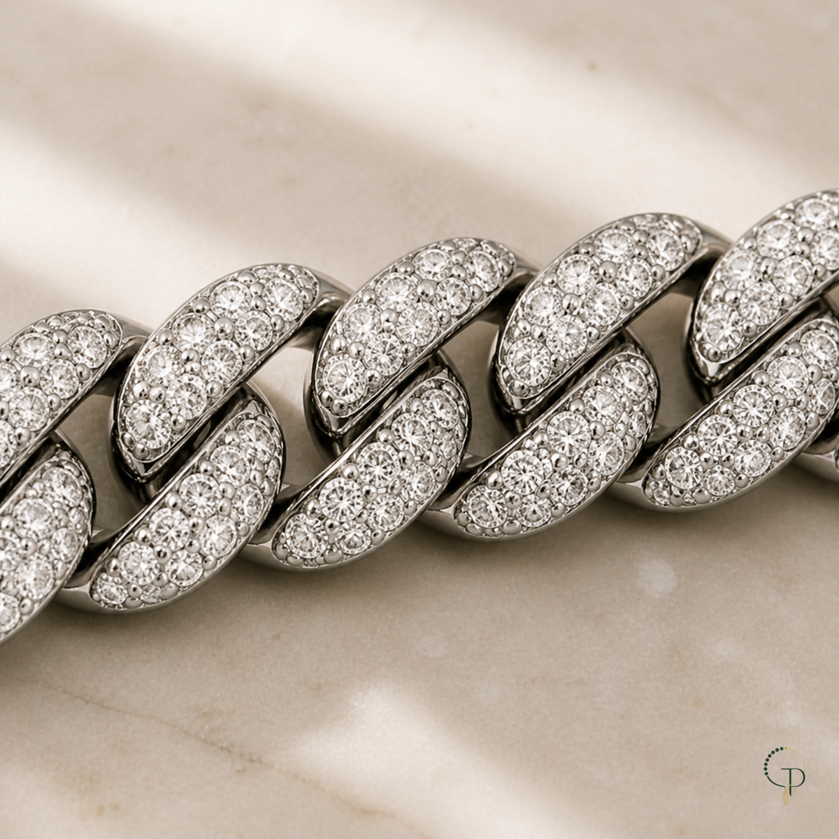 Macro view of clear pavé-style stones across thick Cuban links