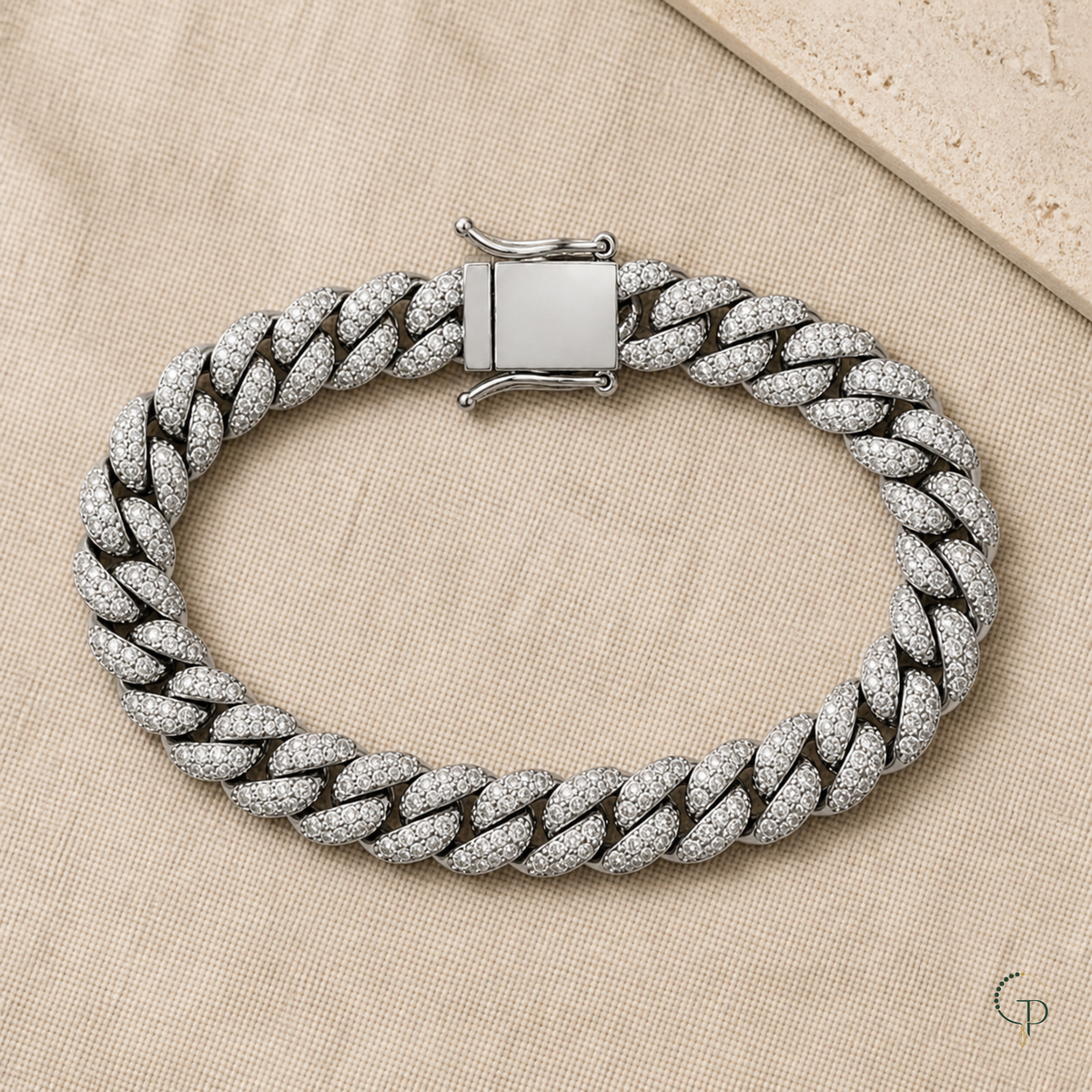 Complete single-row Cuban link bracelet arranged on ivory linen