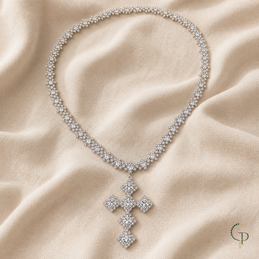 Silver-color square cluster cross statement necklace arranged on warm oatmeal linen