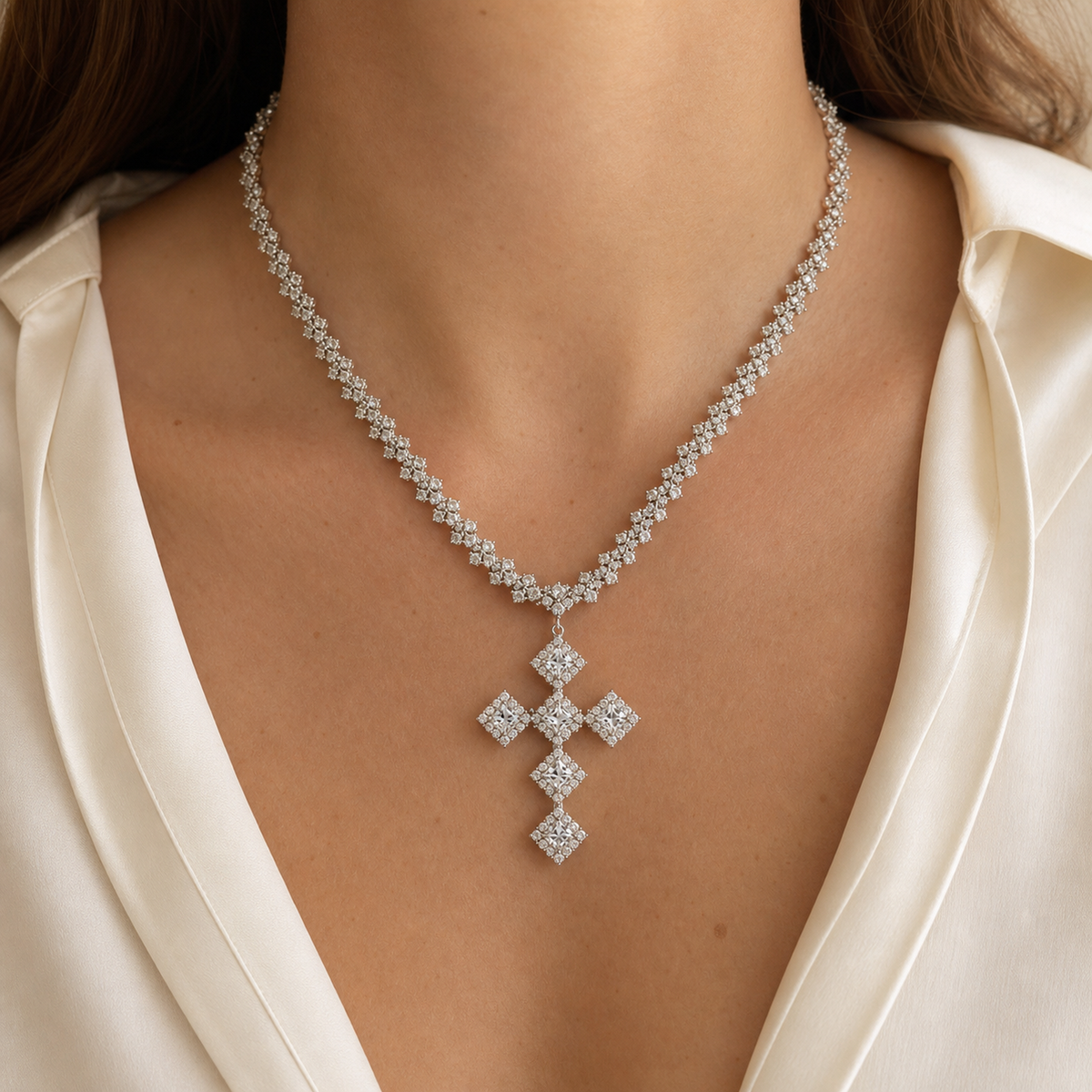 Square cluster cross statement necklace worn with an ivory blouse