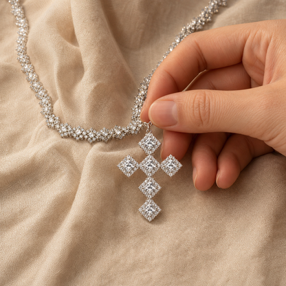 Hand holding the square cluster cross pendant for visual scale