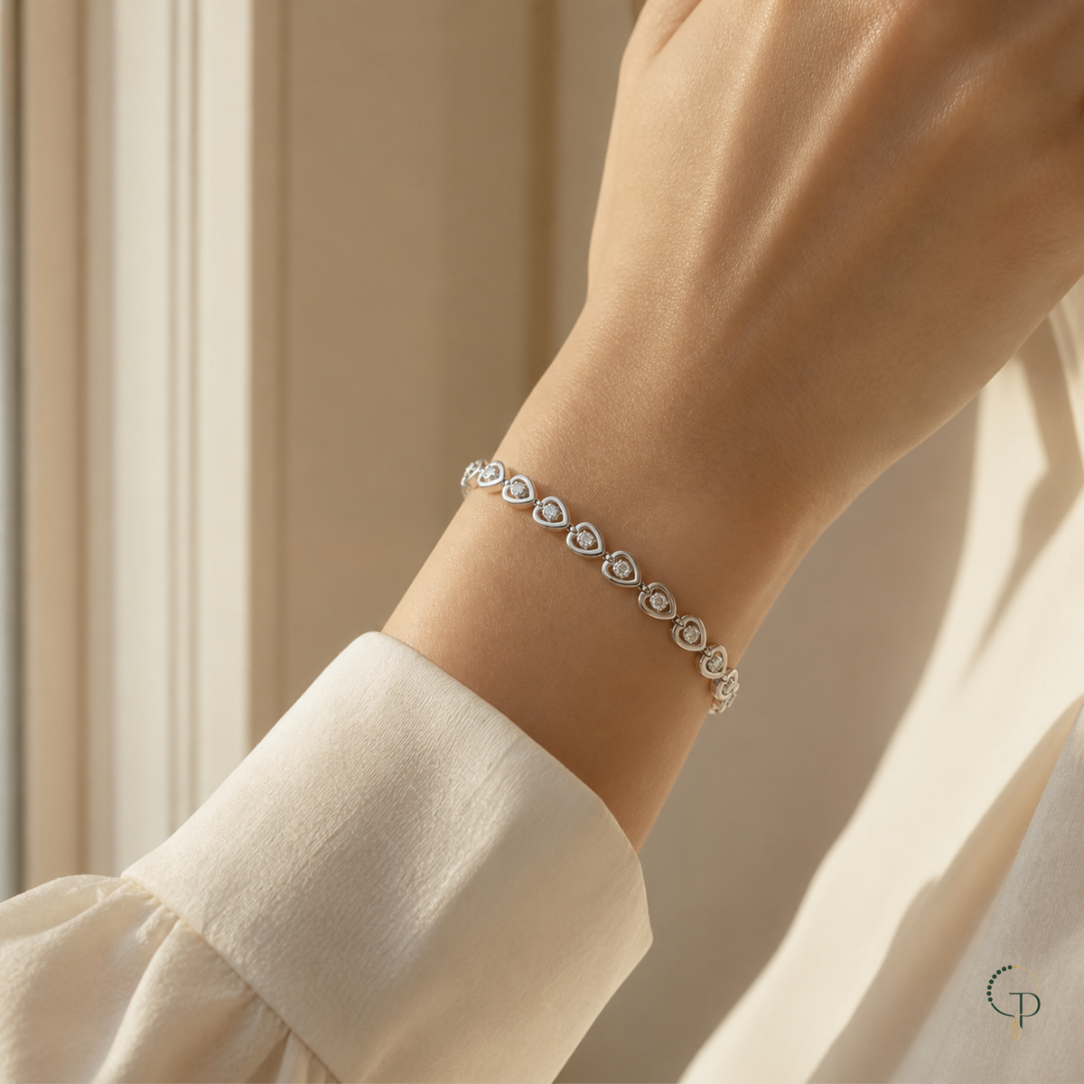 Single-crystal heart link bracelet worn around an anonymous wrist