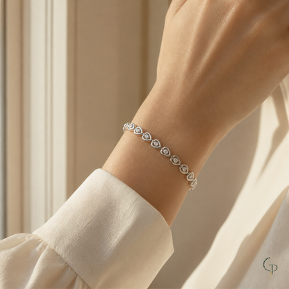 Single-crystal heart link bracelet worn around an anonymous wrist