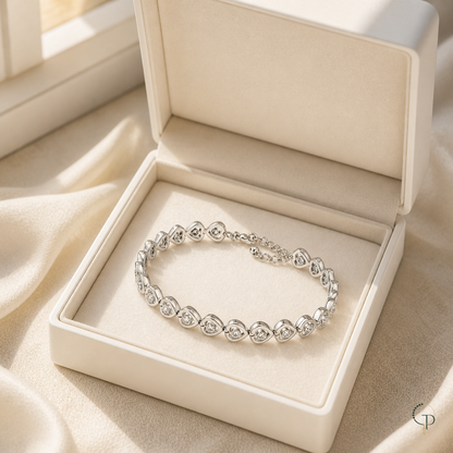 Silver-color heart link bracelet displayed in an unbranded ivory box