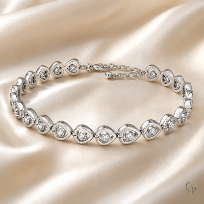 Single-crystal heart link bracelet styled on cream satin