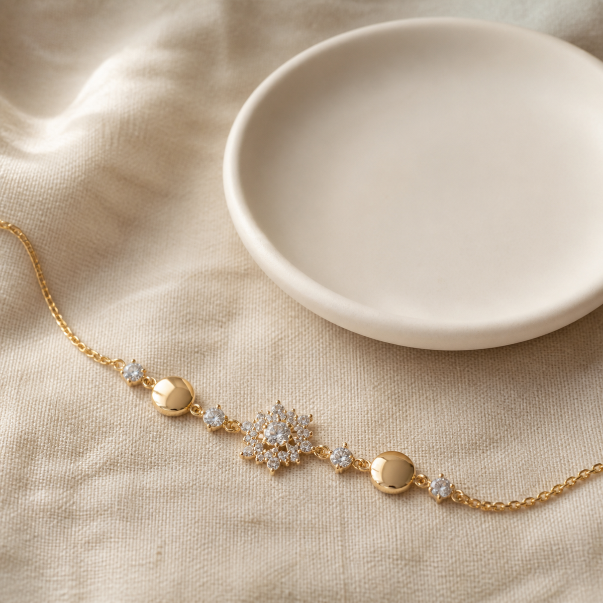Snowflake station bracelet beside an ivory ceramic dish