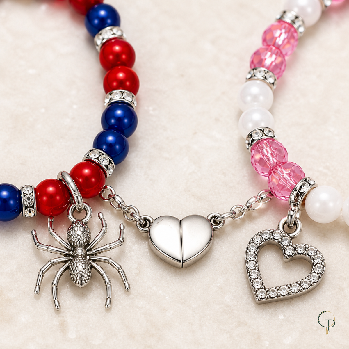Close view of spider charm, pave-style heart charm, and connected magnetic heart