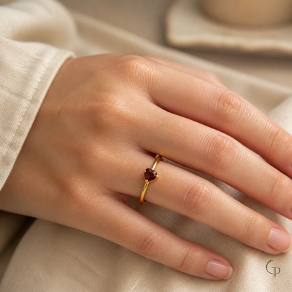 Gold-color petite burgundy heart ring worn on hand