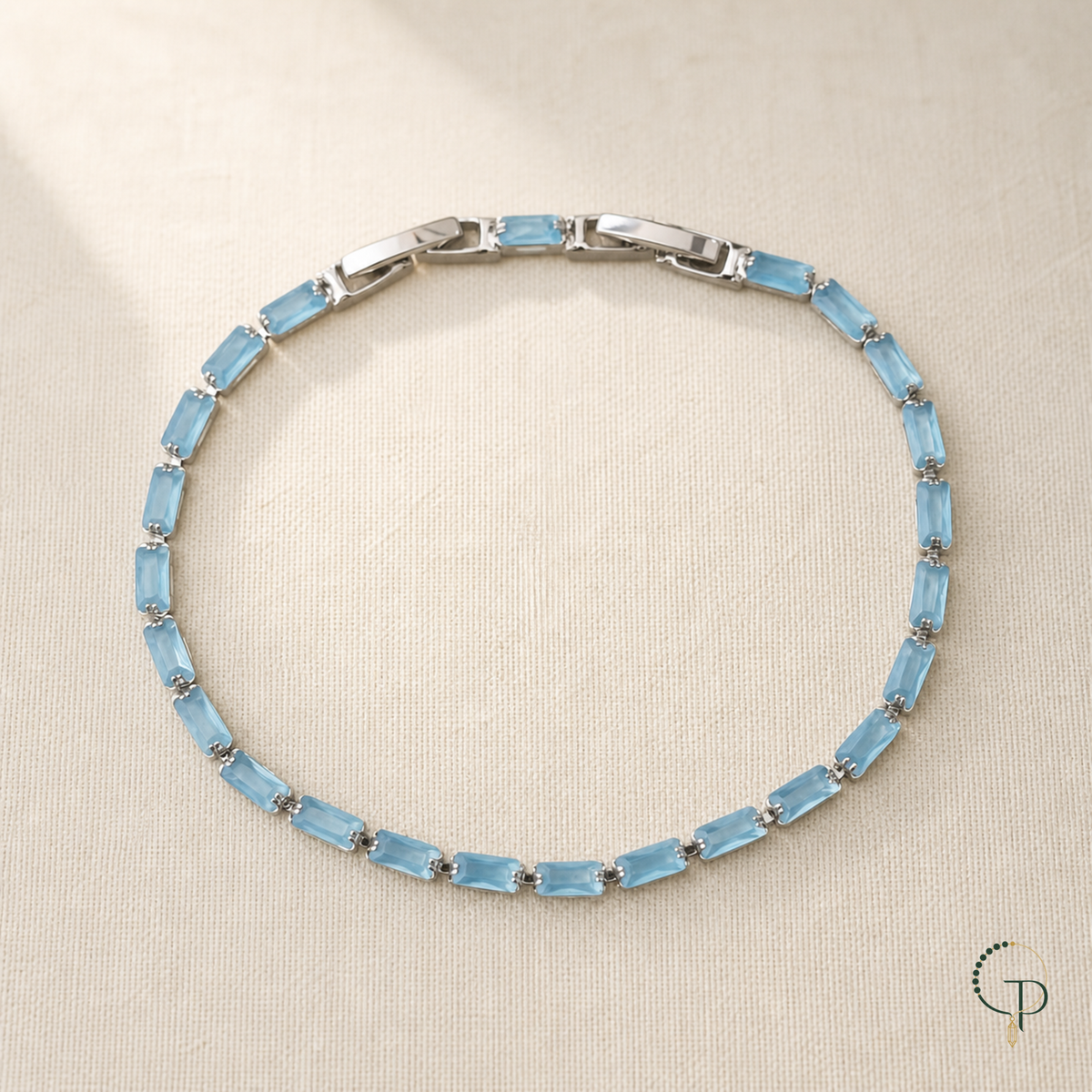 Light blue rectangular stone tennis bracelet on ivory linen | PureNoi