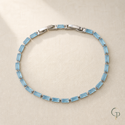 Light blue rectangular stone tennis bracelet on ivory linen | PureNoi