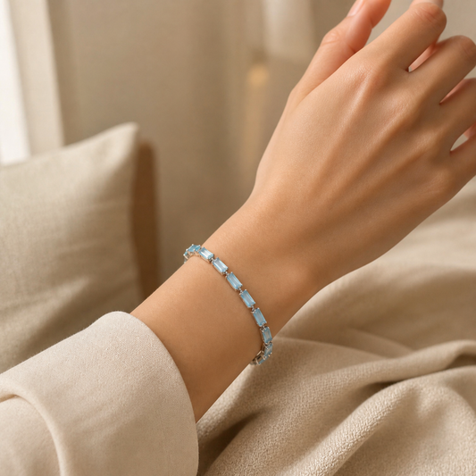 Light blue rectangular tennis bracelet worn with a neutral outfit