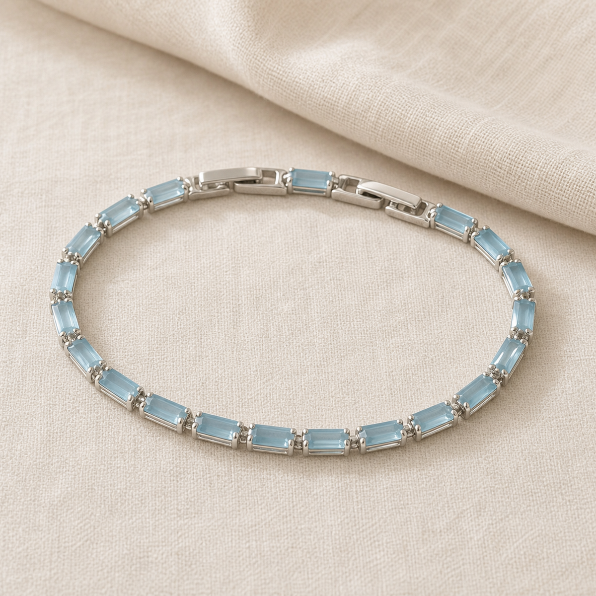 Full light blue rectangular stone tennis bracelet on ivory fabric