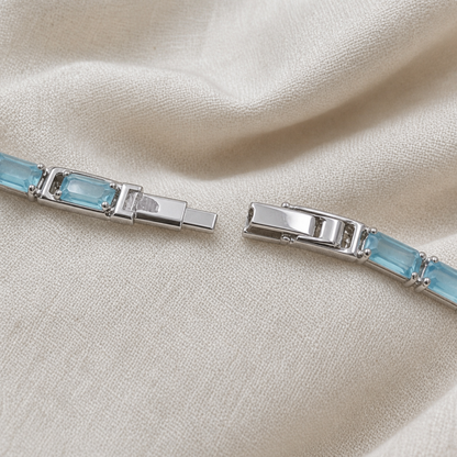 Close-up of clasp and linked setting on light blue tennis bracelet