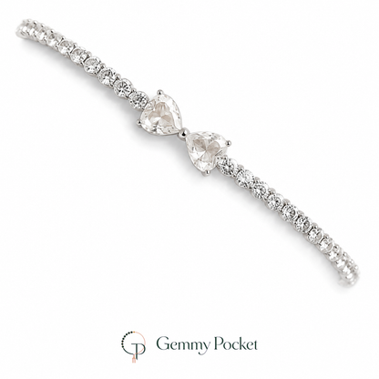 Silver-color twin heart bow tennis bracelet on a white studio background