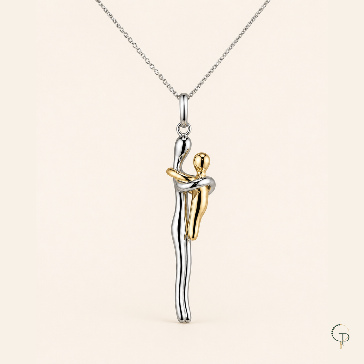 Close view of the taller silver-color and smaller gold-color figures embracing