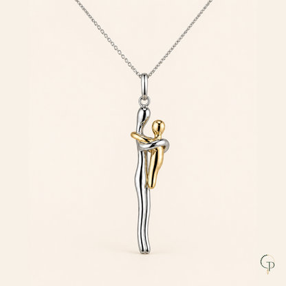 Close view of the taller silver-color and smaller gold-color figures embracing