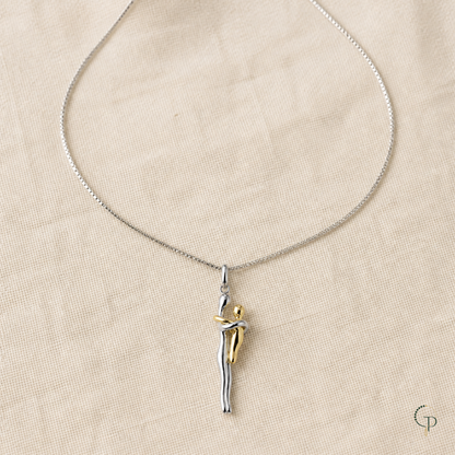 Fine silver-color necklace with two-tone figure pendant arranged on oatmeal linen