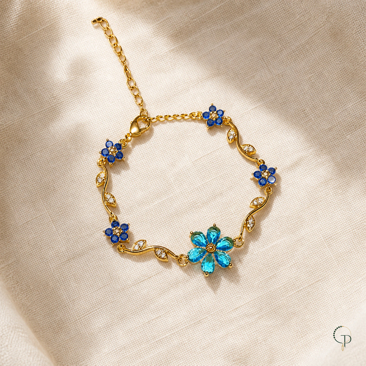 Blue floral vine bracelet with aqua and deep-blue flowers on oatmeal linen