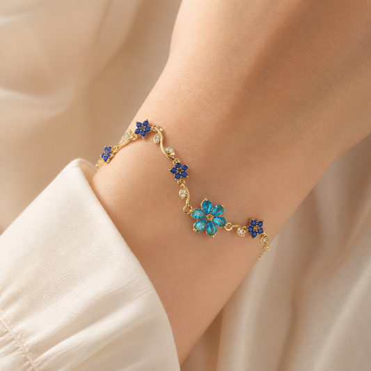 Gold-color blue flower vine bracelet worn alone on the wrist